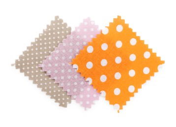 Photo of Samples of fabrics with polka dot pattern isolated on white, top view