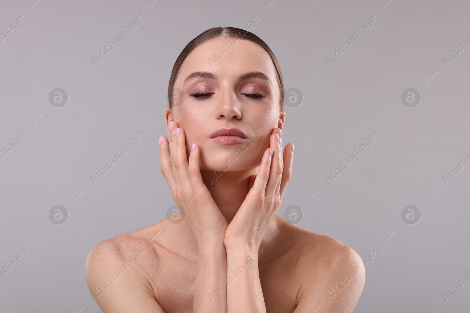 Portrait of beautiful young woman on gray background Photo of Portrait of beautiful young woman on gray background