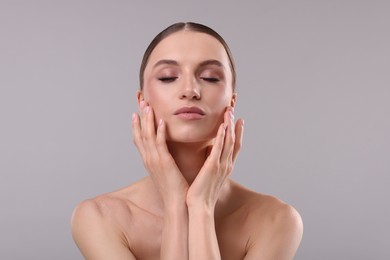 Photo of Portrait of beautiful young woman on gray background