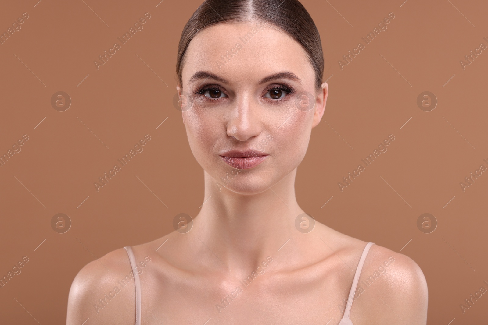 Portrait of beautiful young woman on beige background Photo of Portrait of beautiful young woman on beige background