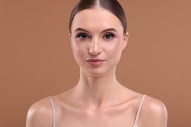 Photo of Portrait of beautiful young woman on beige background