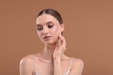 Photo of Portrait of beautiful young woman on beige background, space for text