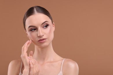 Photo of Portrait of beautiful young woman on beige background, space for text