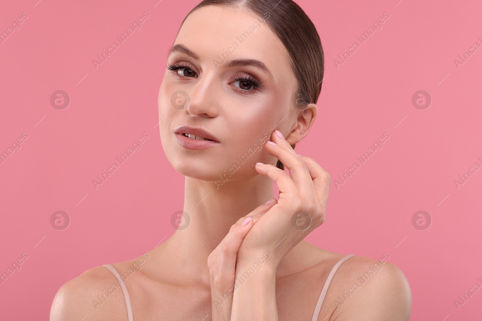 Portrait of beautiful young woman on pink background Photo of Portrait of beautiful young woman on pink background
