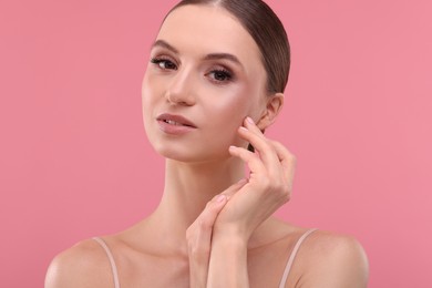 Photo of Portrait of beautiful young woman on pink background