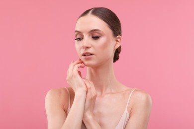 Photo of Portrait of beautiful young woman on pink background