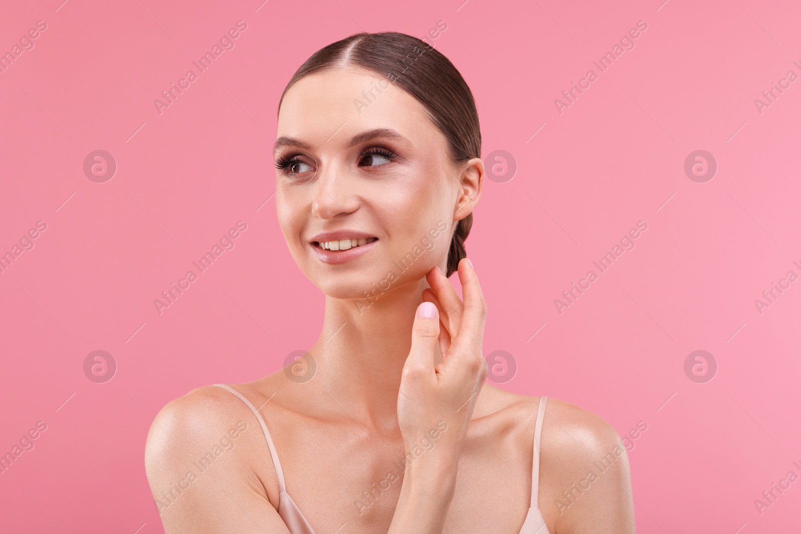 Portrait of beautiful young woman on pink background Photo of Portrait of beautiful young woman on pink background