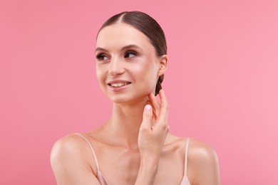 Photo of Portrait of beautiful young woman on pink background