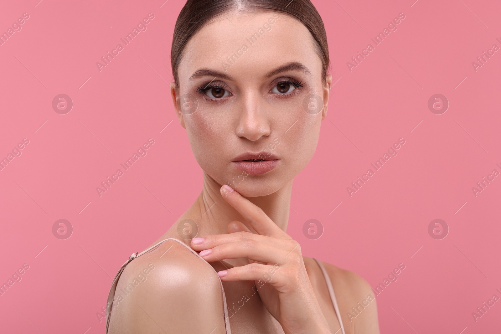 Portrait of beautiful young woman on pink background Photo of Portrait of beautiful young woman on pink background