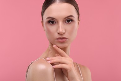 Photo of Portrait of beautiful young woman on pink background