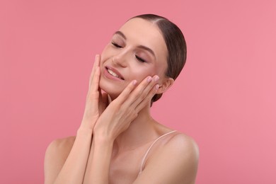 Photo of Portrait of beautiful young woman on pink background