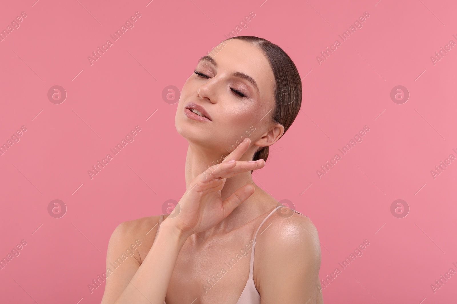 Portrait of beautiful young woman on pink background Photo of Portrait of beautiful young woman on pink background
