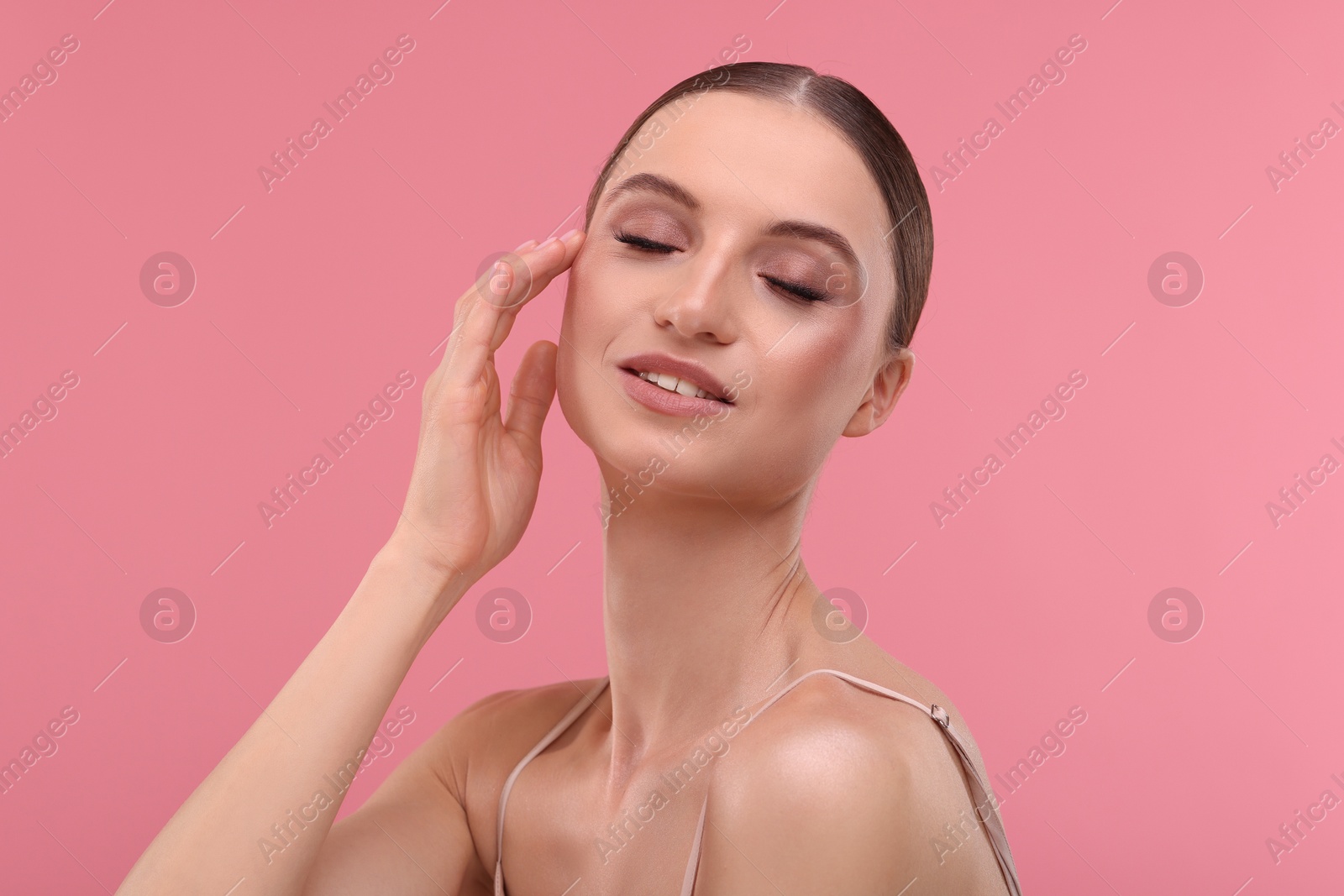 Portrait of beautiful young woman on pink background Photo of Portrait of beautiful young woman on pink background
