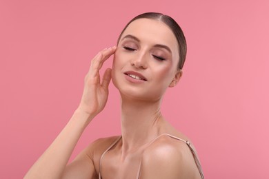 Photo of Portrait of beautiful young woman on pink background