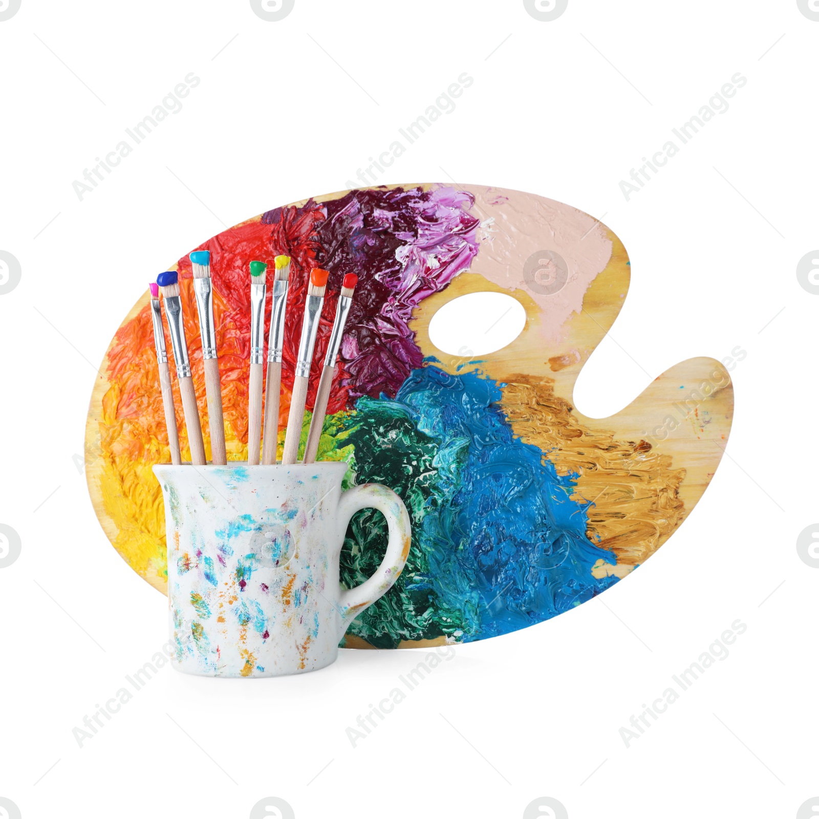 Brushes with color paints and palette isolated on white Photo of Brushes with color paints and palette isolated on white