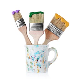 Photo of Brushes with color paints in cup isolated on white