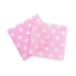 Photo of Samples of fabrics with polka dot pattern isolated on white, top view