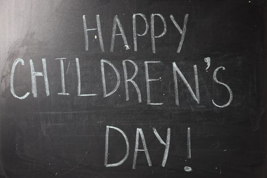 Photo of Phrase Happy Children’s Day with exclamation mark on blackboard