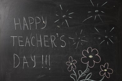 Photo of Phrase Happy Teacher’s Day with exclamation marks and drawings on blackboard