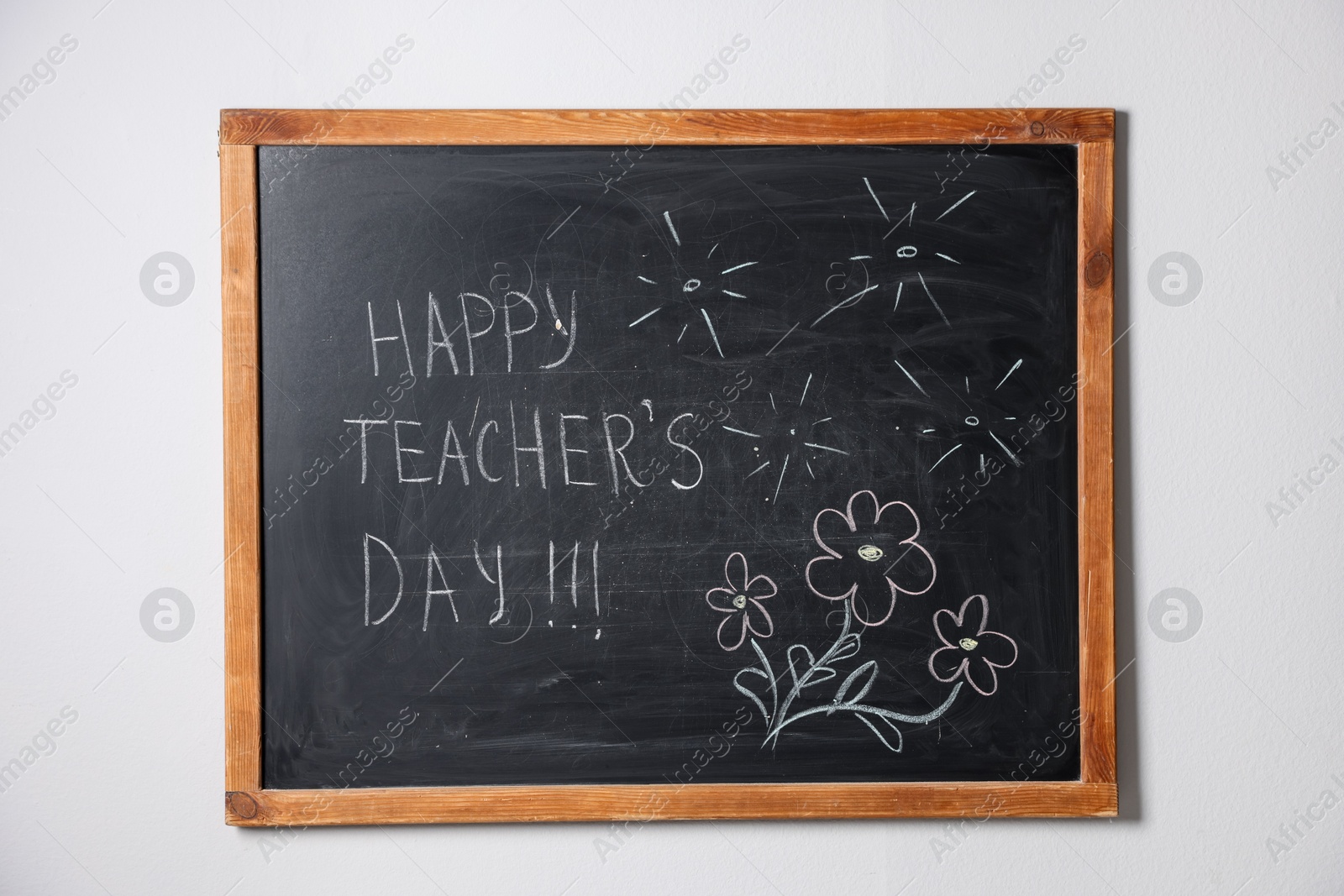 Phrase Happy Teacher’s Day with exclamation marks and drawings on blackboard Photo of Phrase Happy Teacher’s Day with exclamation marks and drawings on blackboard