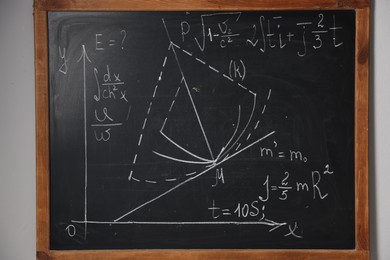 Photo of Black chalkboard with different mathematical formulas on wall