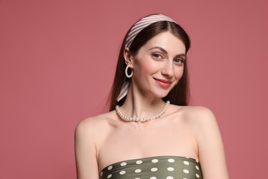 Photo of Fashionable portrait of beautiful woman in stylish outfit on pink background