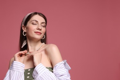 Photo of Fashionable portrait of beautiful woman in stylish outfit on pink background. Space for text