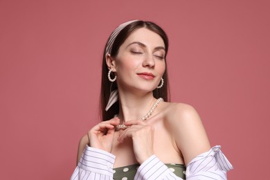 Photo of Fashionable portrait of beautiful woman in stylish outfit on pink background