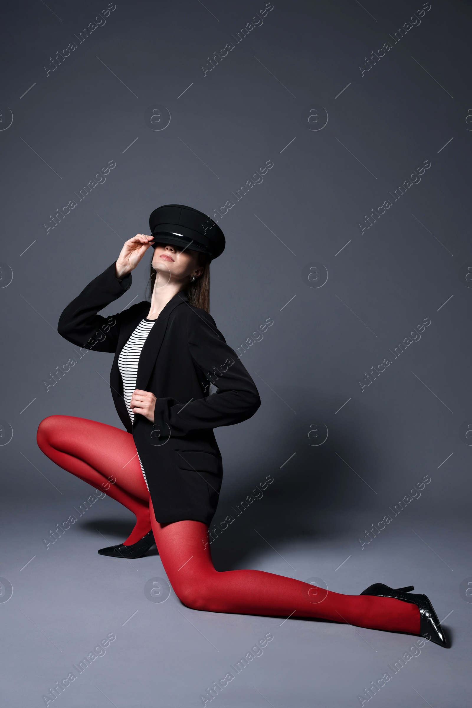 Fashionable portrait of beautiful woman in stylish outfit on grey background. Space for text Photo of Fashionable portrait of beautiful woman in stylish outfit on grey background. Space for text