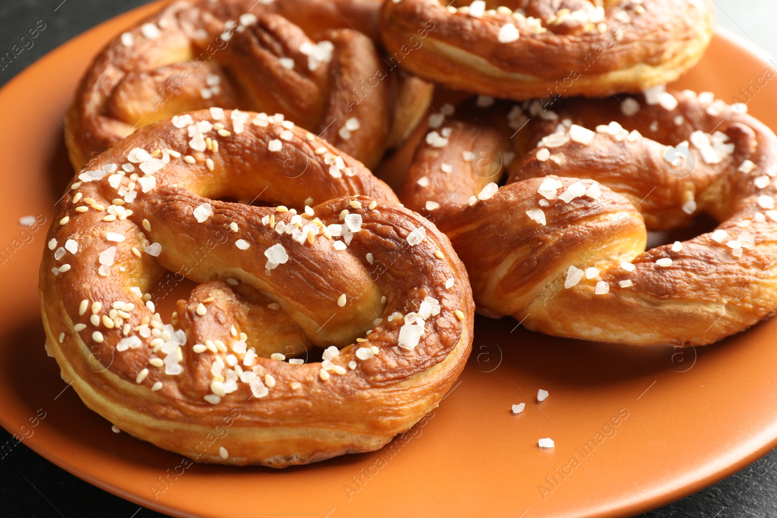 Tasty pretzels with salt on table, closeup Photo of Tasty pretzels with salt on table, closeup