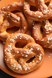 Photo of Tasty pretzels with salt on table, top view
