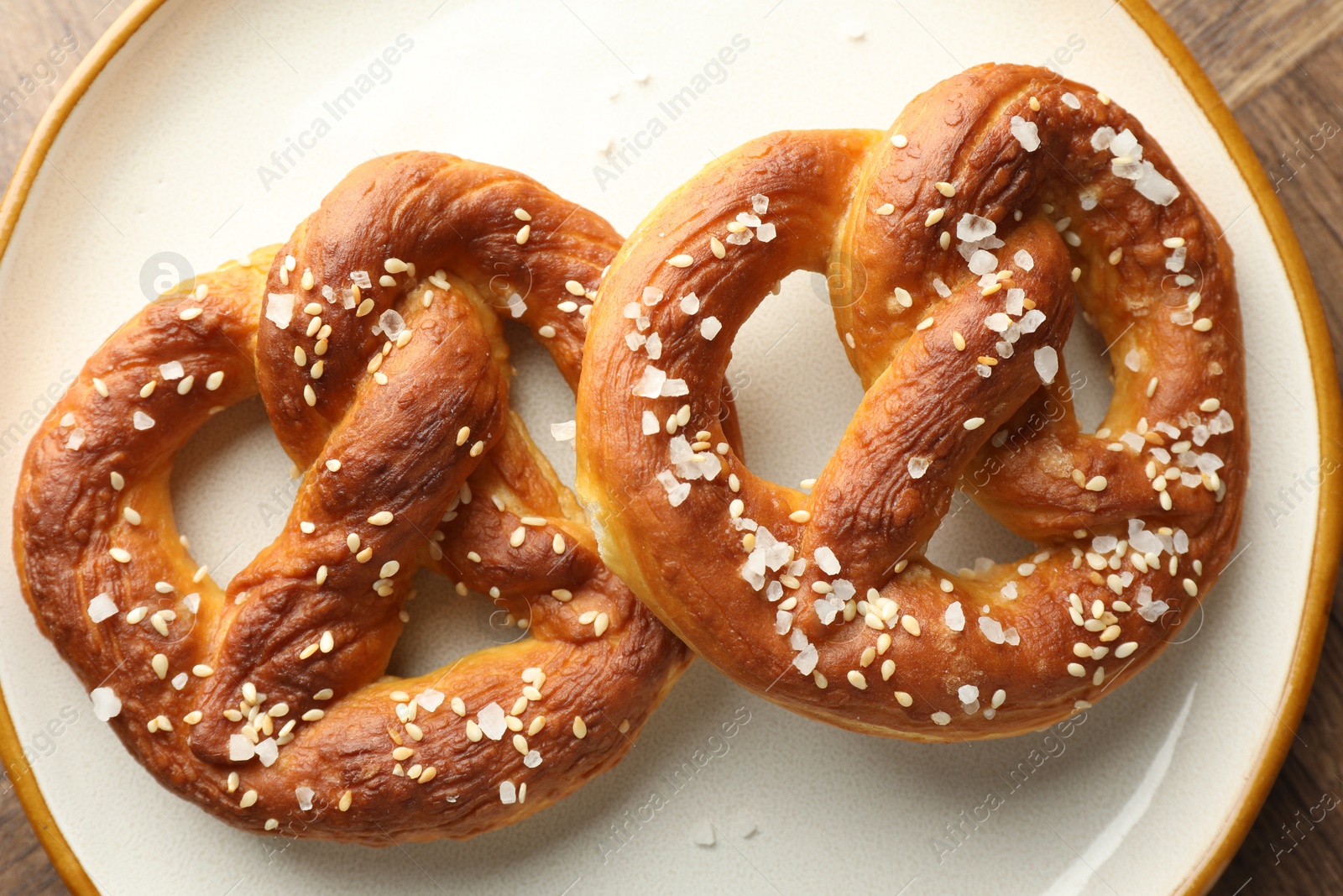 Tasty pretzels with salt on table, top view Photo of Tasty pretzels with salt on table, top view