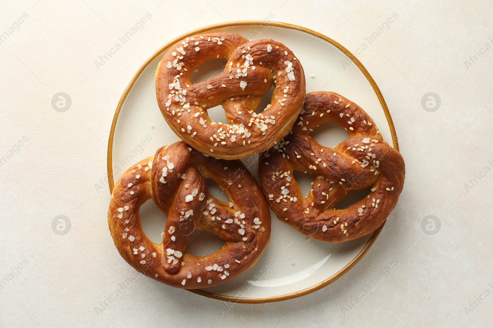 Tasty pretzels with salt on white table, top view Photo of Tasty pretzels with salt on white table, top view