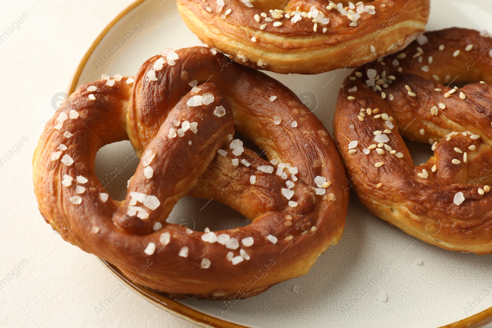 Tasty pretzels with salt on white table, closeup Photo of Tasty pretzels with salt on white table, closeup
