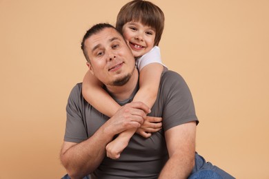 Photo of Father and his son on beige background