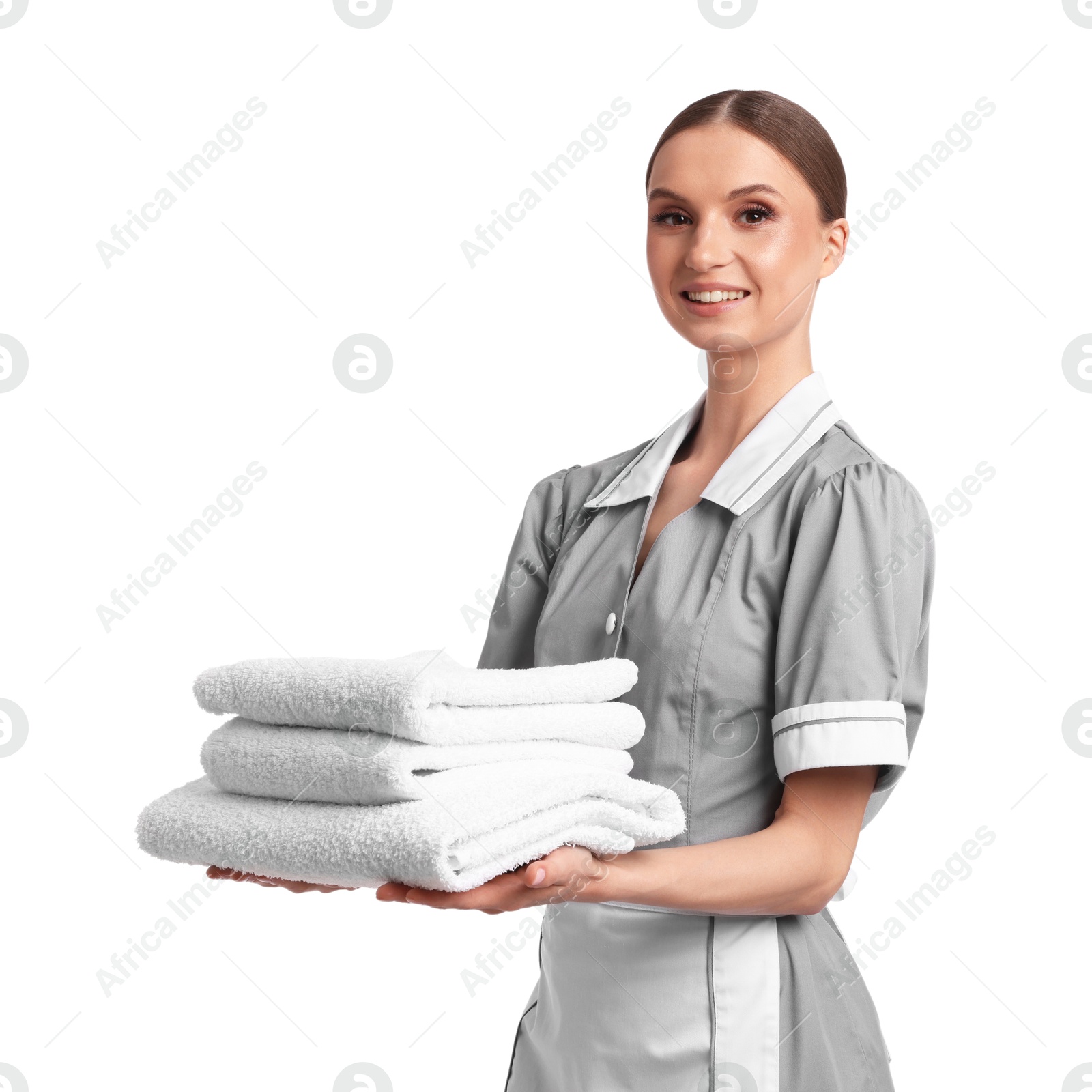 Chambermaid with stack of clean towels on white background Photo of Chambermaid with stack of clean towels on white background