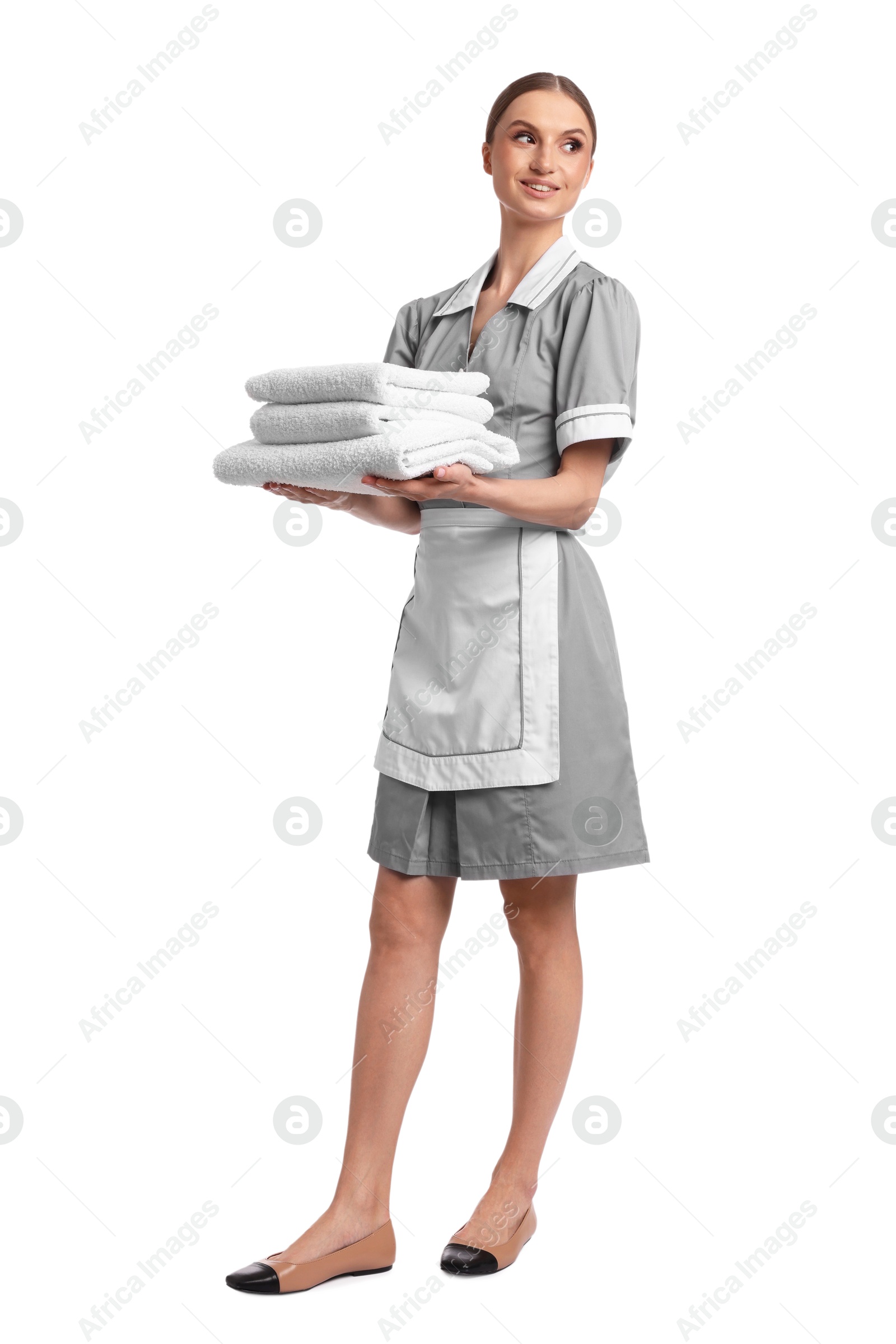 Chambermaid with stack of clean towels on white background Photo of Chambermaid with stack of clean towels on white background