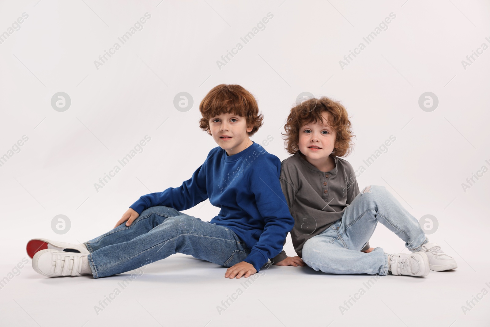 Cute little brothers posing on white background Photo of Cute little brothers posing on white background