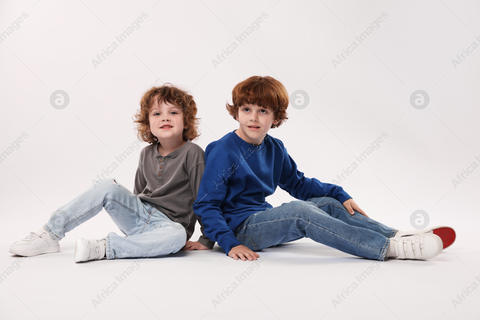Cute little brothers posing on white background Photo of Cute little brothers posing on white background