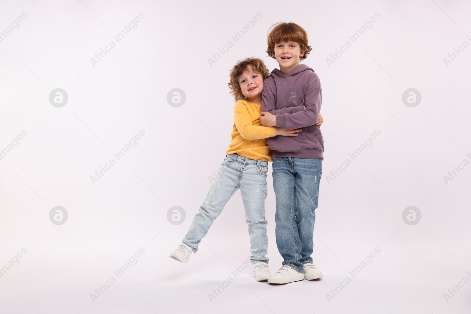 Cute little brothers hugging on white background Photo of Cute little brothers hugging on white background