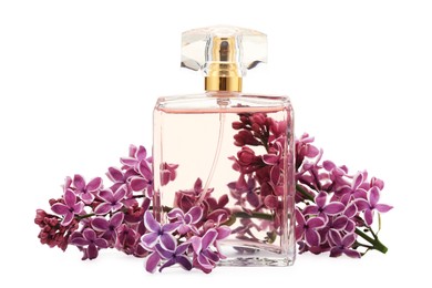 Photo of Bottle of luxury perfume and lilac flowers isolated on white