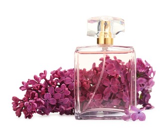 Photo of Bottle of luxury perfume and lilac flowers isolated on white