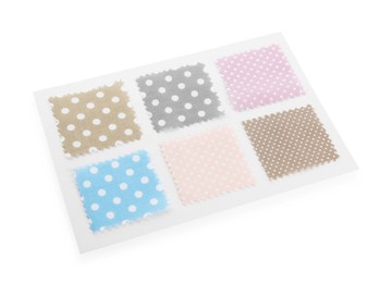 Photo of Samples of fabrics with polka dot pattern isolated on white