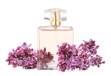 Photo of Bottle of luxury perfume and lilac flowers isolated on white