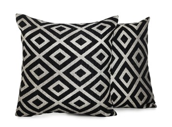 Photo of Two stylish cushions with pattern isolated on white