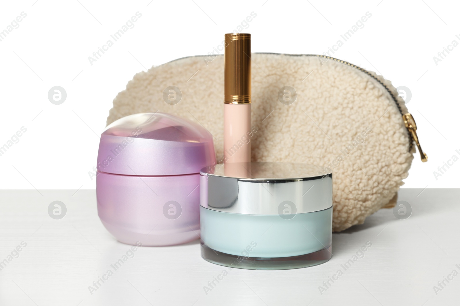 Cosmetic products and bag isolated on white Photo of Cosmetic products and bag isolated on white