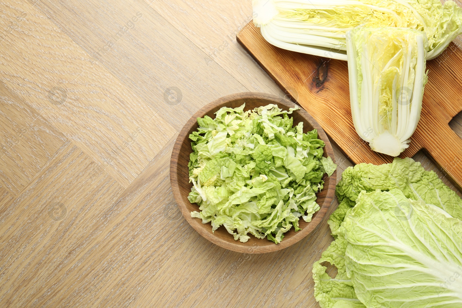 Fresh Chinese cabbages on wooden table, flat lay. Space for text Photo of Fresh Chinese cabbages on wooden table, flat lay. Space for text