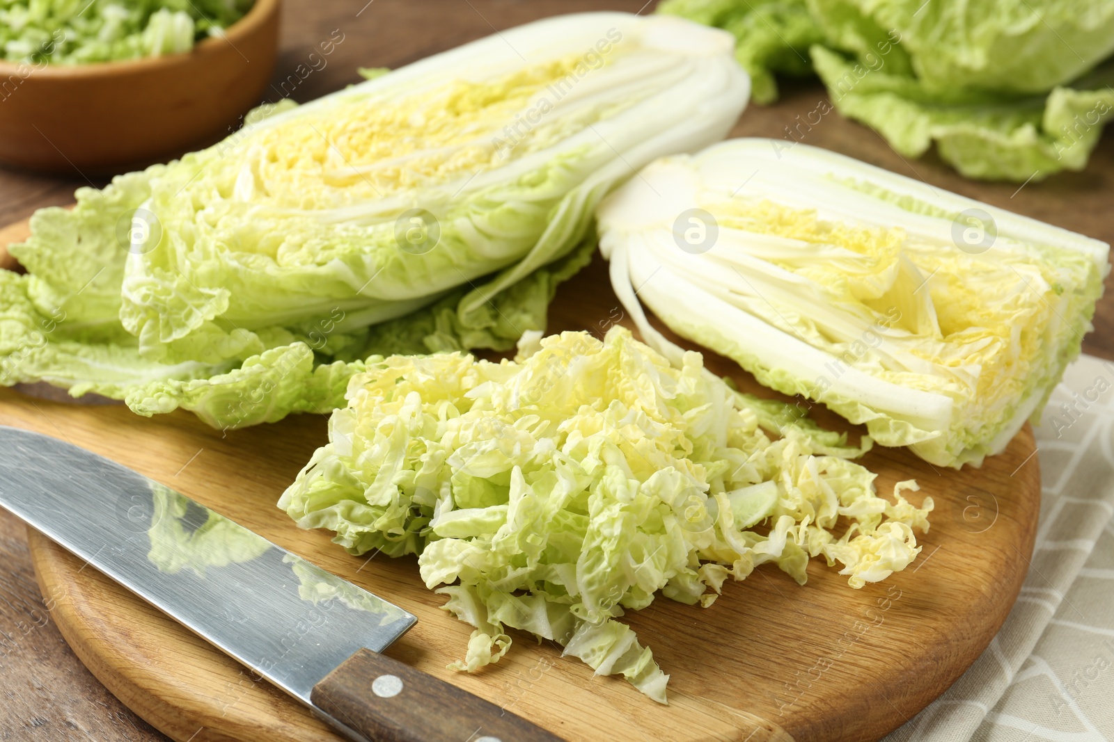 Fresh Chinese cabbages and knife on wooden table, closeup Photo of Fresh Chinese cabbages and knife on wooden table, closeup
