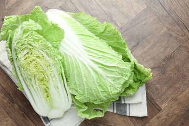 Photo of Fresh Chinese cabbages on wooden table, top view