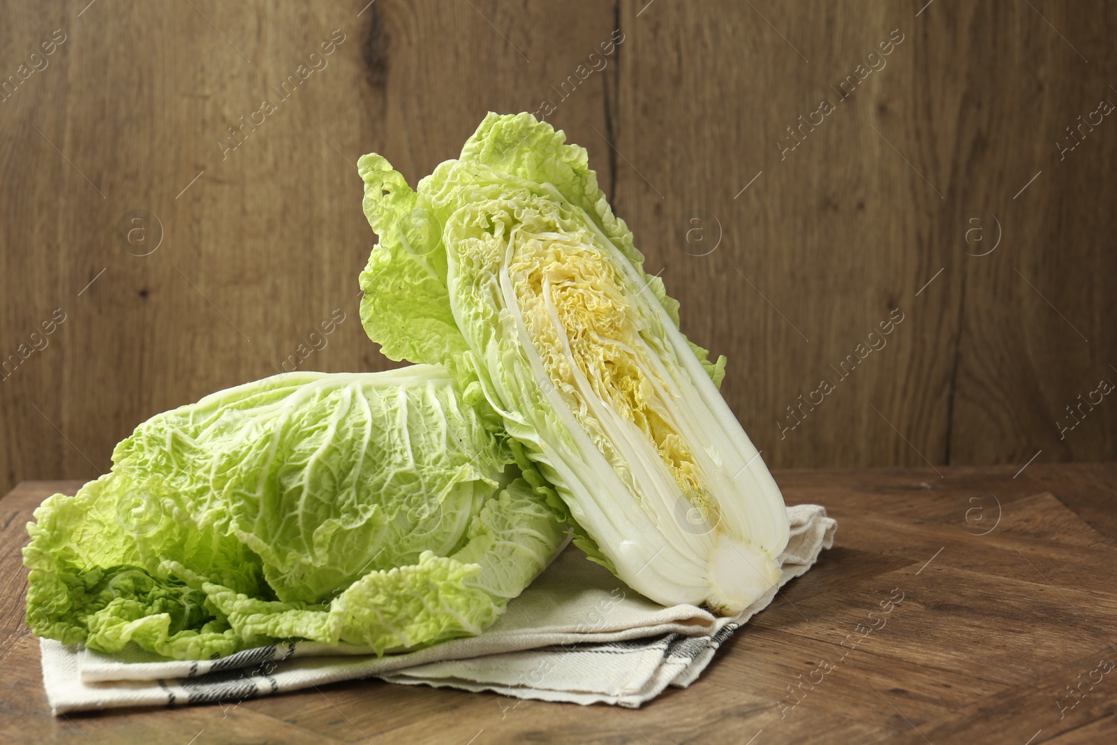 Fresh Chinese cabbages on wooden table, space for text Photo of Fresh Chinese cabbages on wooden table, space for text